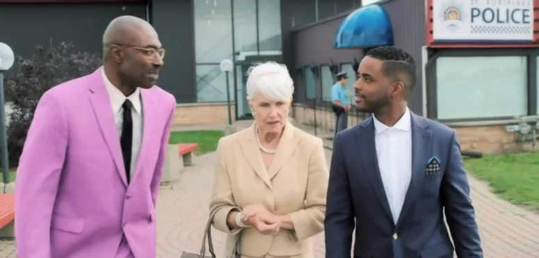 Conrad Coates as Financial Regulator Claude Higgins (left) seen here bailing Zachery and Murk’s former secretary (Barbara Gordon) out of trouble on the fictional island (and tax haven) of St. Euripides