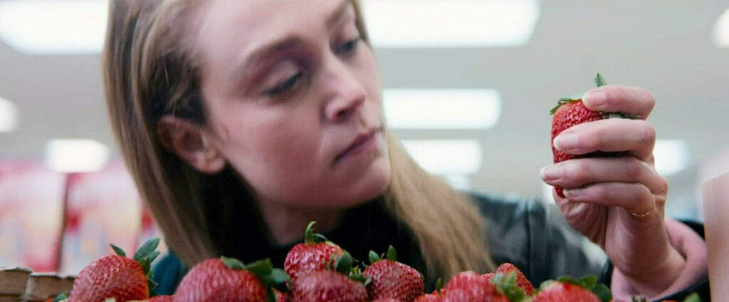 After abstaining from blood, vampire Anna (Alanna Bale) studies a strawberry - Kicking Blood