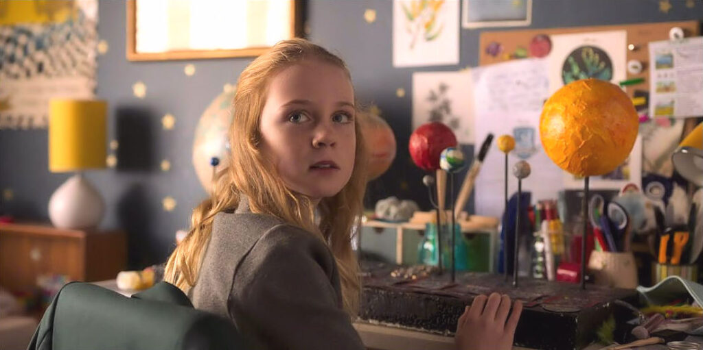 Gary’s daughter Emma (Ariel Donoghue) with her model of the solar system
