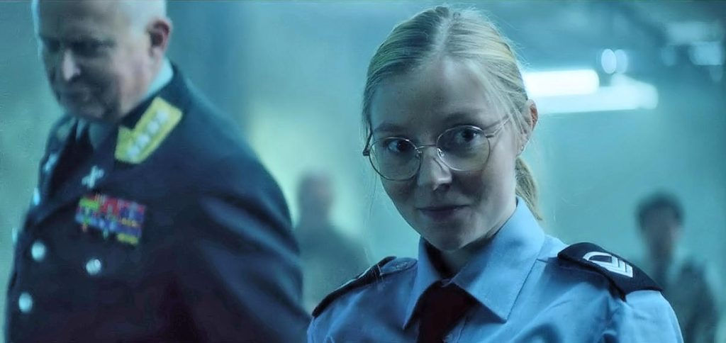 Karoline Viktoria Sletteng Garvang as Sigurd looking pleased with herself after saving the day (and punching out a general). - Troll