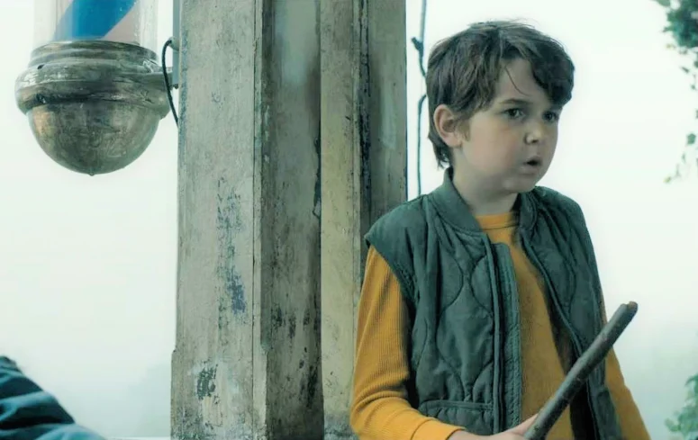 Ethan (Simon Webster) on the porch of Colony House.