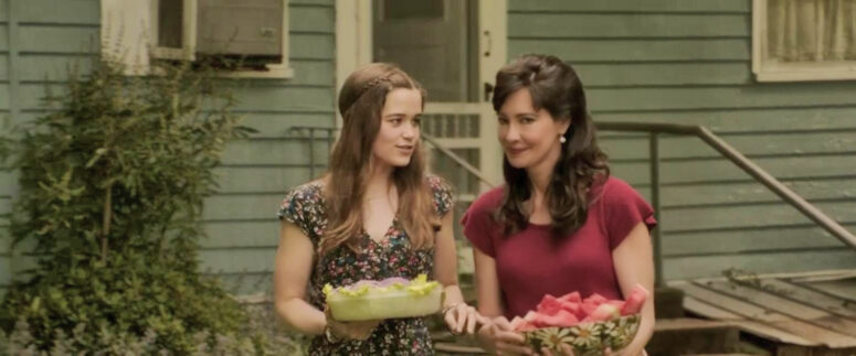 Debbie Glatzel (Sarah Catherine Hook) carries flowers in The Conjuring