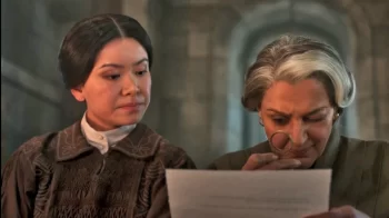 Verrin (Meera Syal) and Yassica (Katie Leung) of the Brown Ajah begin a Holmesian investigation into the disappearance of Egwene and the others. - The Wheel of Time 205