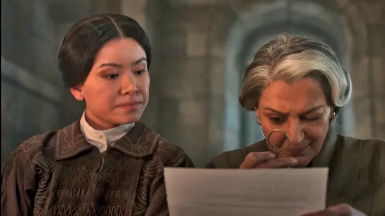 Verrin (Meera Syal) and Yassica (Katie Leung) of the Brown Ajah begin a Holmesian investigation into the disappearance of Egwene and the others. - The Wheel of Time 205