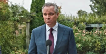 Wendell Collins (Scott Fee) looking worried in a blue suit - Wild Cards