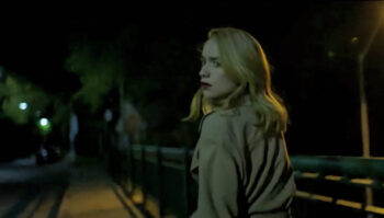 Suspecting she is being followed, Merle James (Melanie Scrofano) looks suspiciously over her shoulder - Birdland