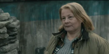 Donna (Elizabeth Saunders) builds a cairn in front of the spot where Dale died.- From 306