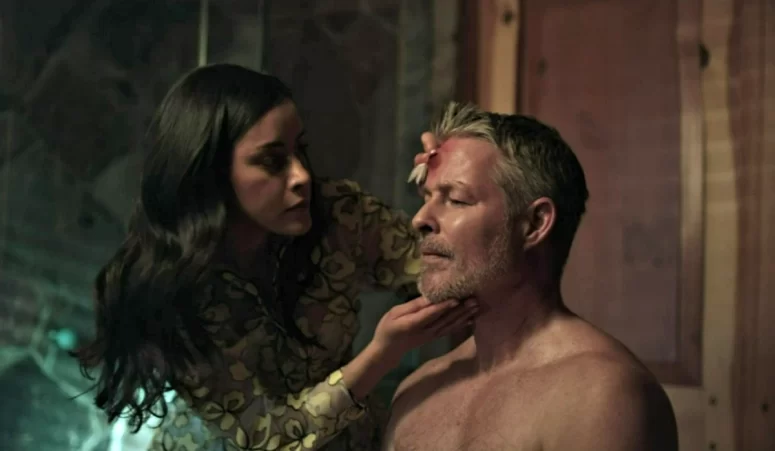 Kai (Dianne Aguilar) cares for Clayton (Sebastian Spence) after Olivia hits him with a shovel.