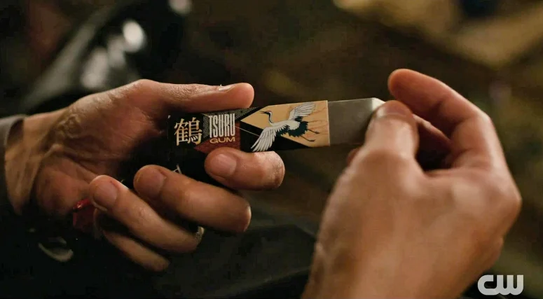 Tomo Hayashi extracts a stick of gum - the same brand that Parole Officer Howard offered to George in the previous episode - Wild Cards 308