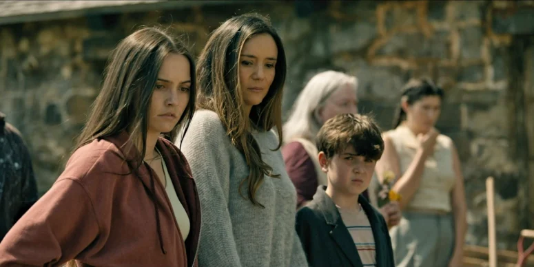 The Matthews family (Catalina Sandino Moreno, Hanna Cheramy, and Simon Webster) at the funeral for Jim and the pastor - From 403