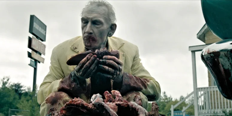 The Man in Yellow (Douglas E Hughes) eating a freshly harvested organ from a corpse circa 1979 - From 404