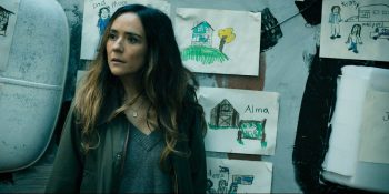 Tabitha standing in front of the RV which has Ethan's drawings posted on its roof - From 408