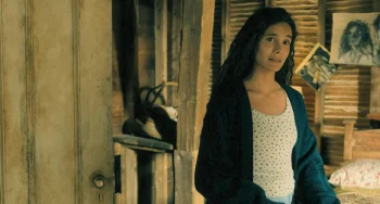 Fatima (Pegah Ghafoori) talking to Ellis with his image of her in the form of a drawing in the background - From 408