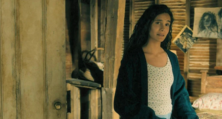 Fatima (Pegah Ghafoori) talking to Ellis with his image of her in the form of a drawing in the background - From 408