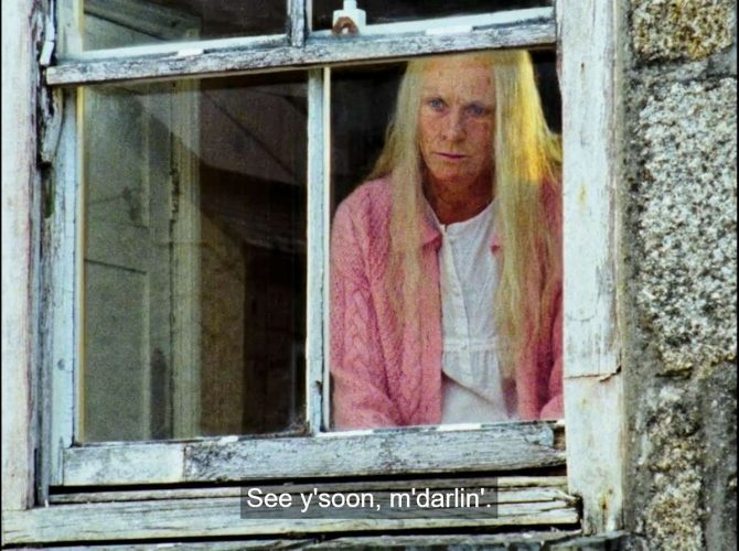 Mary Woodvine as Mrs. Richards looking out her window